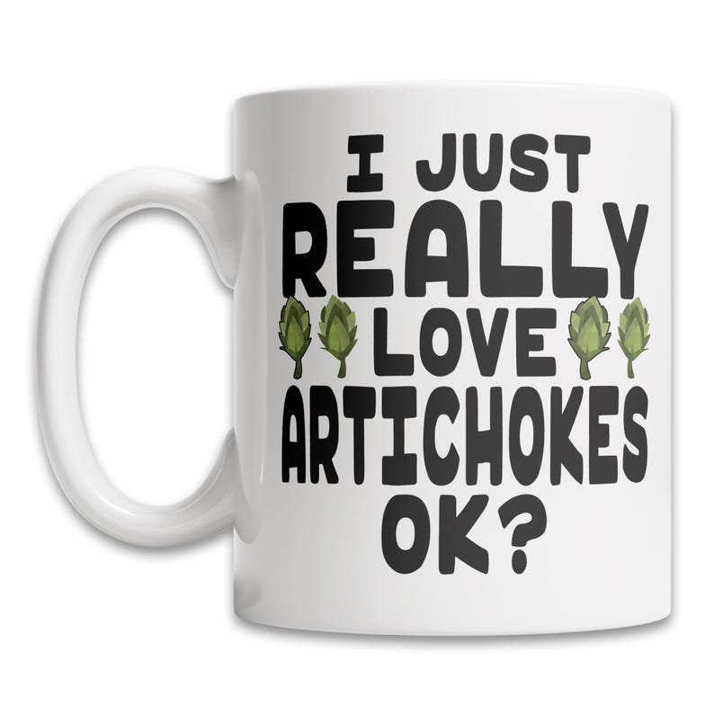 May include: White ceramic coffee mug with a black and green design. The mug has a black handle and the text "I just really love artichokes ok?" printed on the front.