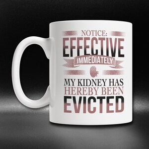 May include: White ceramic mug with a black and pink design. The text on the mug reads "Notice: Effective Immediately My Kidney Has Hereby Been Evicted."