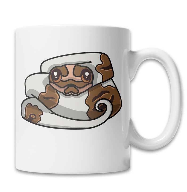 May include: White ceramic coffee mug with a cartoon illustration of a brown and white snake with big eyes. The snake is curled up in a ball.