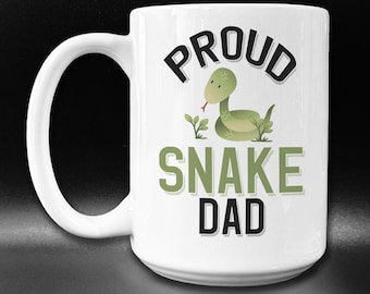 May include: White ceramic mug with a green snake illustration and the text "Proud Snake Dad" in black lettering.