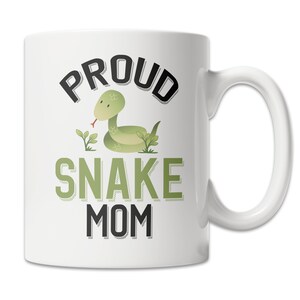 May include: White ceramic coffee mug with a green snake illustration and the text "Proud Snake Mom" in black.
