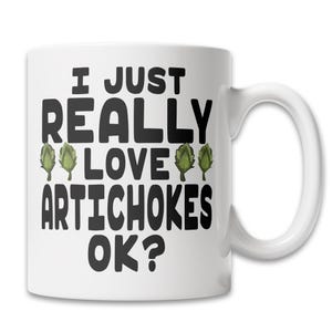 May include: White ceramic coffee mug with black text that reads "I just really love artichokes ok?" with three green artichoke illustrations.