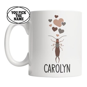 May include: White ceramic mug with a brown earwig illustration and hearts. The text "CAROLYN" is printed below the earwig.