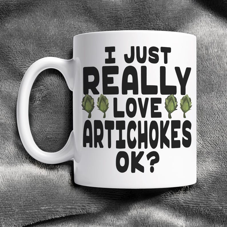 May include: White ceramic coffee mug with a black graphic that says "I just really love artichokes ok?" with three green artichoke illustrations.