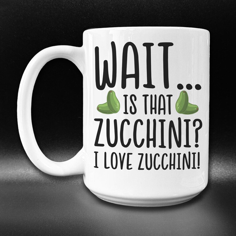 May include: White ceramic mug with a black and green design. The mug has the text "WAIT... IS THAT ZUCCHINI? I LOVE ZUCCHINI!" printed on it.