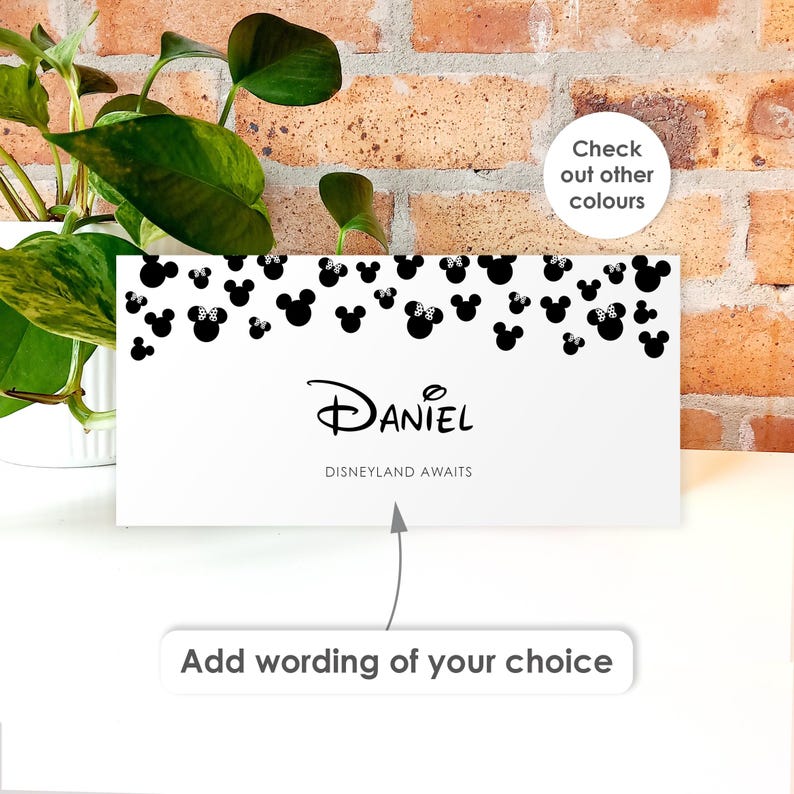 May include: A white rectangular card featuring a pattern of black Mickey and Minnie Mouse silhouettes at the top. The text reads Daniel and Disneyland Awaits. A separate white label below displays the text Add wording of your choice.