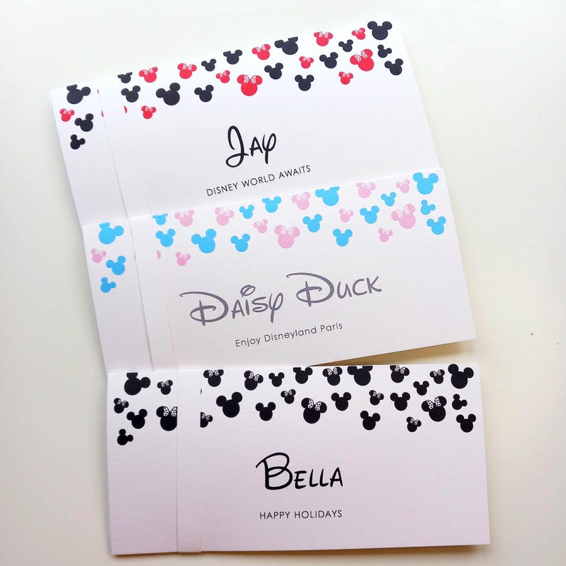 May include: Three white rectangular cards featuring black, red, blue, and pink mouse-ear silhouettes. The top card says Jay and Disney World Awaits. The middle card says Daisy Duck and Enjoy Disneyland Paris. The bottom card says Bella and Happy Holidays.