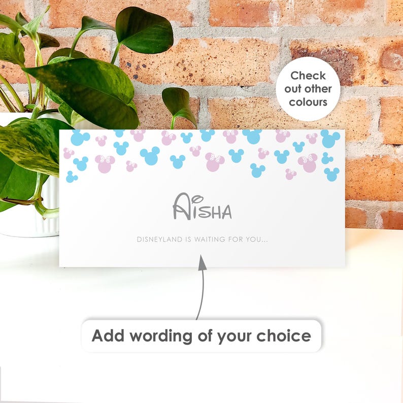 May include: A rectangular white card featuring a pattern of light blue and light pink mouse silhouettes at the top. The center displays the name Aisha in gray text, followed by the phrase Disneyland is waiting for you.