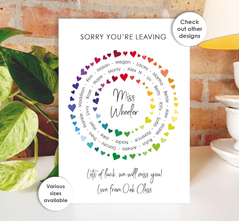 May include: A white card with the text "SORRY YOU'RE LEAVING" and "Miss Wheeler." A colorful heart-shaped wreath surrounds the text, with names inside. The card also includes the text "Lots of luck, we will miss you! Love from Oak Class."