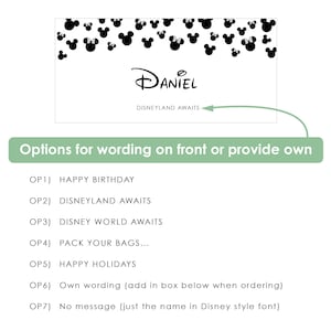 May include: A rectangular white card featuring a black Mickey Mouse and Minnie Mouse head pattern along the top edge. The center displays the name Daniel in a stylized font, with the text Disneyland Awaits printed below it.