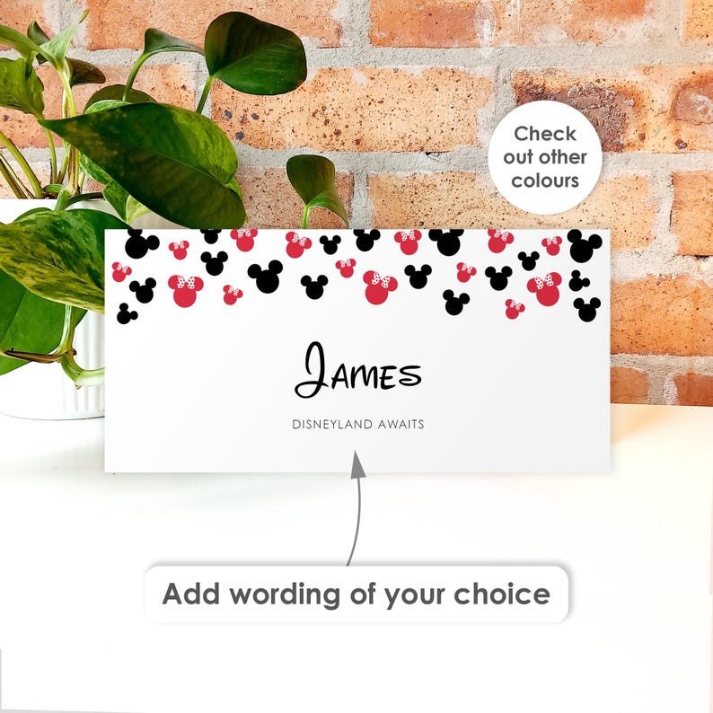 May include: A rectangular white sign featuring a pattern of black and red mouse silhouettes along the top edge. The center displays the name James in black script, followed by the text Disneyland Awaits in a simple font.