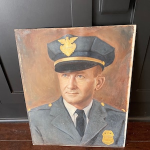 May include: A painting of a man in a police uniform. He is wearing a blue hat with a gold badge that says "Lieutenant". He is also wearing a blue jacket with a gold badge that says "Police".