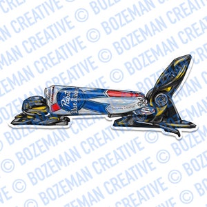 May include: A black and yellow robot holding a can of Pabst Blue Ribbon beer. The robot is lying on its side with its arms outstretched.