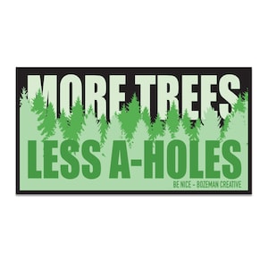 Pode incluir: Um adesivo preto e verde com o texto "More Trees Less A-Holes" e uma silhueta de uma floresta no fundo. O texto "Be Nice - Bozeman Creative" está na parte inferior do adesivo.