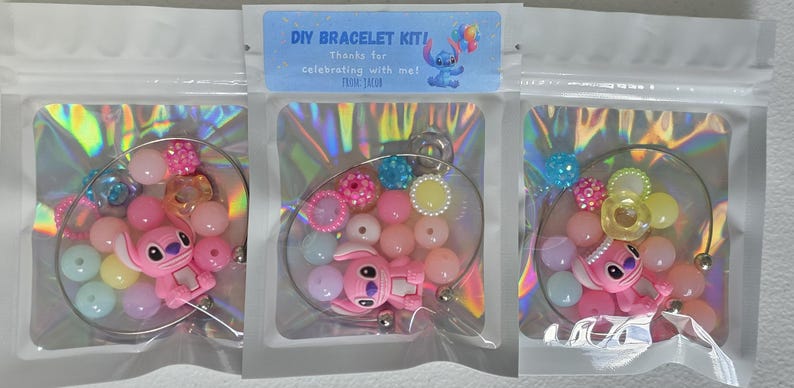 May include: DIY bracelet kits in clear plastic bags. Each kit contains a pink Stitch character charm, colourful beads, and decorative elements. The kits are designed for making bracelets and feature a variety of pastel colours.