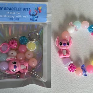 May include: DIY bracelet kit with pink and pastel beads, a pink Stitch charm, and a clear plastic package with the text "DIY BRACELET KIT!" and "Thanks for celebrating with me! From Jacob."