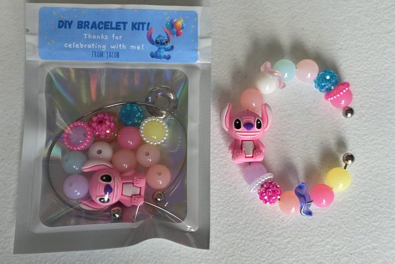 May include: DIY bracelet kit with pink and pastel beads, a pink Stitch charm, and a clear plastic package with the text "DIY BRACELET KIT!" and "Thanks for celebrating with me! From Jacob."