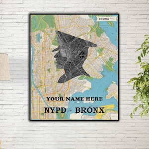 May include: A framed map print of the Bronx, New York, featuring a black silhouette of a police officer's profile. The map uses green, yellow, and blue tones. Text reads "YOUR NAME HERE" and "NYPD - BRONX".