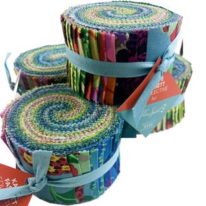 May include: Several fabric rolls, tightly coiled and bound with pale blue ribbon. The fabric displays a colourful array of patterns and hues, including floral and abstract designs. Tags with text are attached.