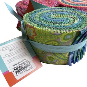 May include: Rolled fabric bundles in shades of green, blue, and pink, tied with light blue ribbon. The fabric features a floral pattern. A tag with product information is attached. The text on the tag includes "Kaffe Fassett Classics Plus-2.5in Design Roll-4pcs".