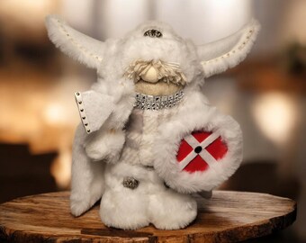 DANISH SHIELDMAIDEN, made in all white with her Danish shield and white axe in hand. She has two long braids with beads braided in.