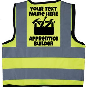 May include: Yellow and grey safety vest with black reflective stripes. The vest has a black patch on the back that says "YOUR TEXT NAME HERE" with a toolbox and tools graphic and the text "APPRENTICE BUILDER".