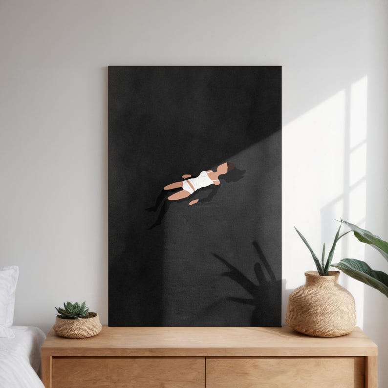 May include: A rectangular wall art print featuring a minimalist illustration of a figure in white clothing floating against a solid black background. The figure is depicted with simple shapes and muted skin tones, centered within the dark vertical frame.