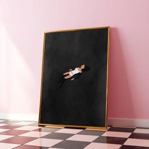 May include: A rectangular wall art print in a thin gold frame featuring a minimalist illustration of a figure in a white top and shorts floating against a solid black background. The artwork is displayed in a vertical orientation.