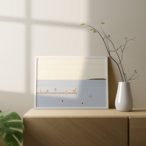 May include: A white framed illustration of a group of people swimming and sunbathing in a blue body of water. The illustration is set against a light blue sky with a faint yellow horizon. The people are depicted in a simple, minimalist style with no facial features. The illustration is a calming and serene depiction of a summer day at the beach.