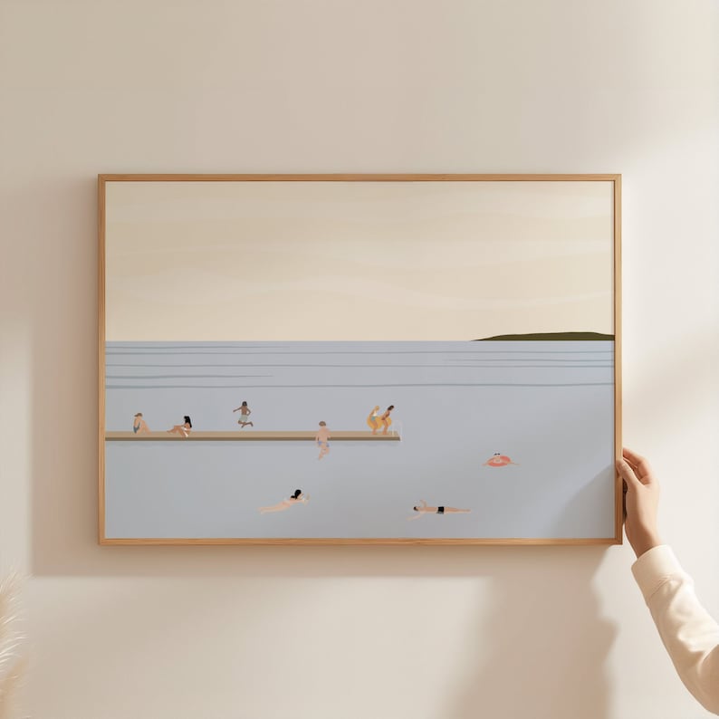 May include: A framed illustration of a light blue seascape with a wooden dock and people swimming and diving in the water. The sky is a light yellow color and there is a small green island in the distance.