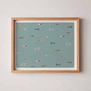May include: A framed art print featuring a teal background with numerous small figures swimming. The swimmers are depicted in various colors, including yellow, red, and purple. The frame is made of light-colored wood.