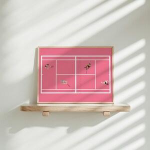 May include: A framed print of a pink tennis court with four figures playing tennis. The print is in a wooden frame and is hanging on a shelf.