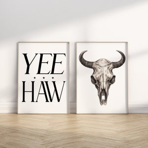 May include: Two framed prints, one with the text "YEE HAW" and the other with a black and white drawing of a bull's skull.