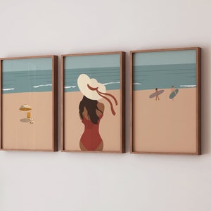 May include: Three framed illustrations of a beach scene. The leftmost illustration shows a beach umbrella and a glass of orange juice. The middle illustration shows a woman in a red swimsuit and a white sun hat. The rightmost illustration shows two people surfing.