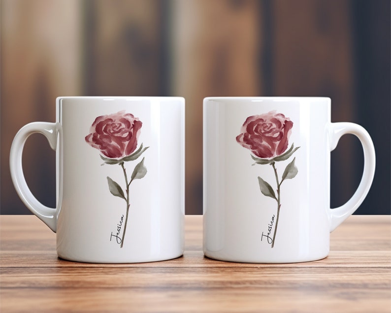 May include: Two white ceramic mugs with a watercolor rose design and the name "Jessica" written on each mug.