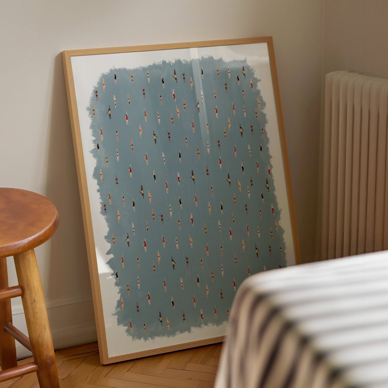 May include: A framed print of a blue background with a repeating pattern of small, colorful figures. The figures are all facing the same direction and appear to be swimming.