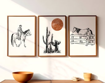 May include: Three framed black and white illustrations of a cowboy riding a horse, a cactus, and a cowboy leaning on a fence with a horse. The illustrations are set against a white background and have a rustic, western theme.