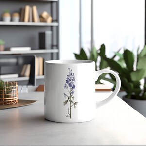 May include: White ceramic mug with a watercolor illustration of a purple flower and the word "Emma" in cursive.