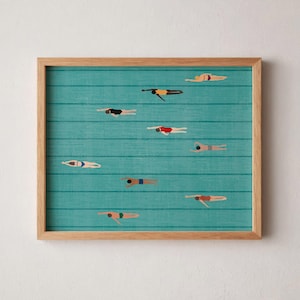 May include: A framed art print showing a teal pool scene with swimmers. The swimmers are wearing swimsuits in various colours, including black, red, and blue. The frame is made of light-coloured wood. The background has horizontal lines.