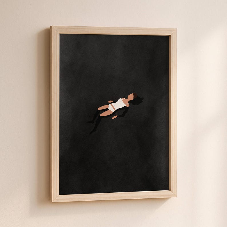 May include: A framed wall art print featuring a minimalist illustration of a figure floating in a vast, solid black space. The figure is depicted with dark hair, wearing a white tank top and white shorts, positioned centrally against the dark background.