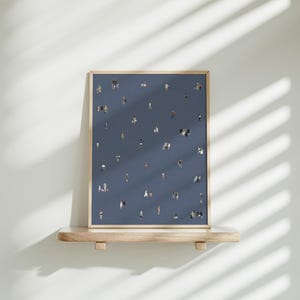 May include: A framed vertical art print featuring a dark blue background populated with numerous tiny, scattered illustrations of people in various poses and outfits, creating a pattern of small figures across the entire surface of the print.