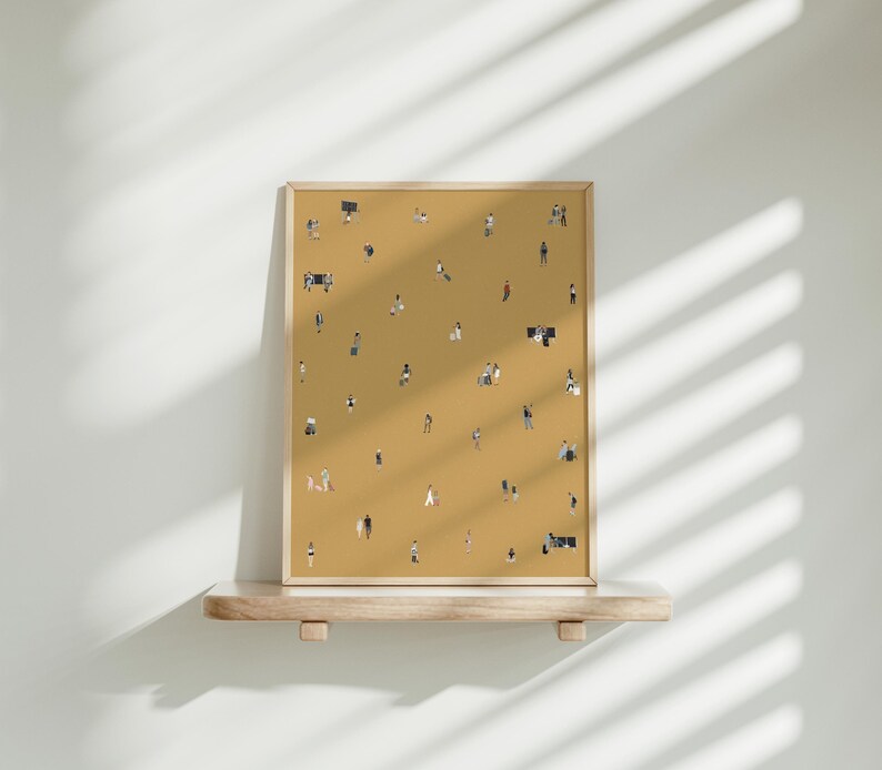 May include: A framed art print featuring a mustard-colored background with numerous tiny figures scattered across it. The figures are depicted in various poses, suggesting a crowd or gathering. The frame is a light wood color, and the print is displayed on a wooden shelf.