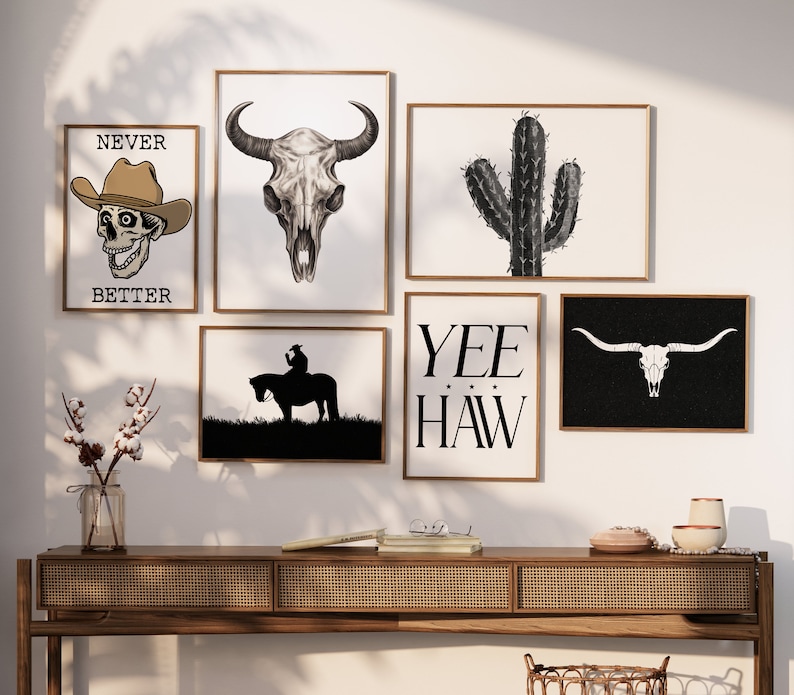 May include: A set of six black and white framed prints with western themes. The prints feature a skull, a cactus, a cowboy riding a horse, and the words "Yee Haw".