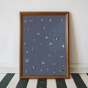 May include: A framed wall art print featuring a dark blue background populated with numerous tiny, illustrated figures of people in various poses, some standing, walking, or sitting, creating a pattern of small, diverse human silhouettes.
