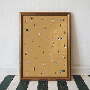 May include: A framed art print featuring a mustard-colored background with numerous tiny figures of people. The figures are dressed in various outfits, suggesting a crowd or gathering. The frame is a warm, medium brown color, adding a classic touch to the artwork.