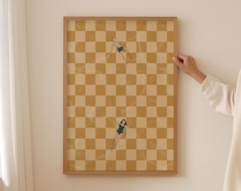 May include: A framed print of a checkered pattern in yellow and brown with two figures in swimsuits floating on top. The figures are a man and a woman.