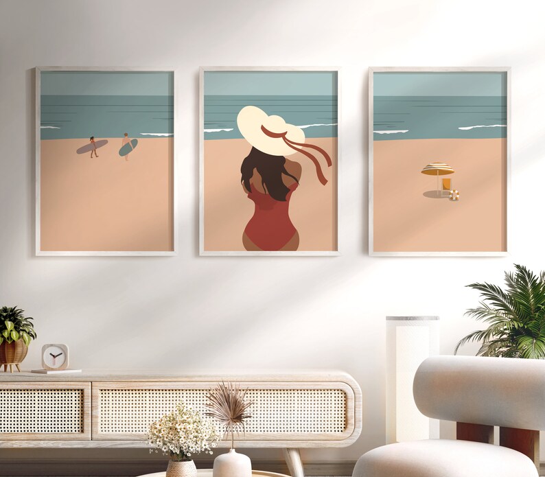 May include: Three framed illustrations of a beach scene. The leftmost illustration shows two people surfing. The middle illustration shows a woman in a red swimsuit and a large white sun hat. The rightmost illustration shows a beach umbrella and a beach chair.