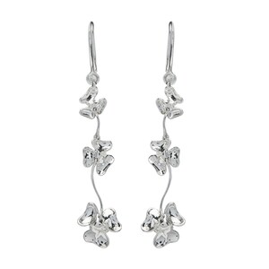 May include: Silver dangle earrings with three clover-shaped charms on each earring.