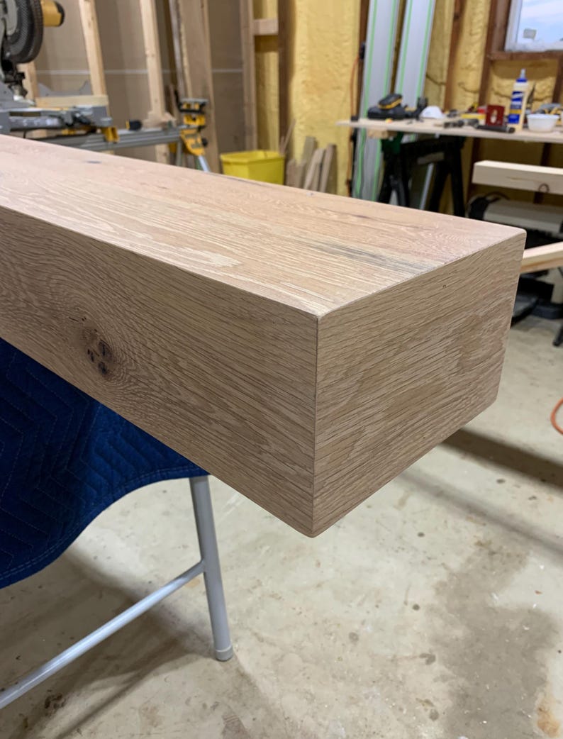 May include: A close-up of a light brown wooden shelf, showing the grain of the wood and the smooth, finished edges.