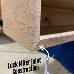 May include: Close-up of a lock miter joint construction on a wooden shelf. The joint is a type of woodworking joint that is used to join two pieces of wood at a 45-degree angle. The joint is strong and durable, and it is often used in furniture making.